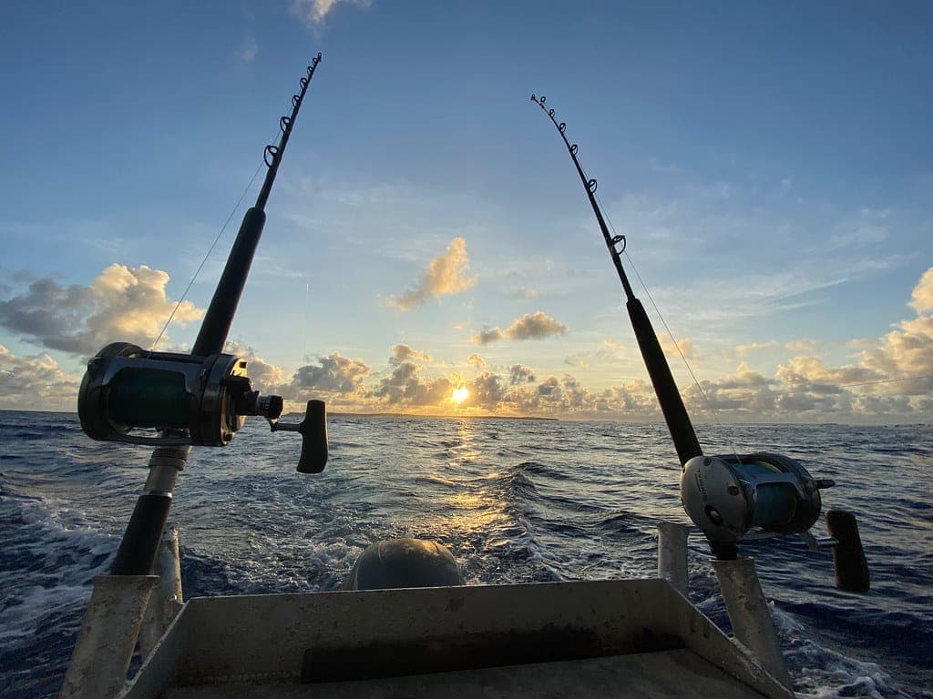 Fishing rods set in a boat at sunrise