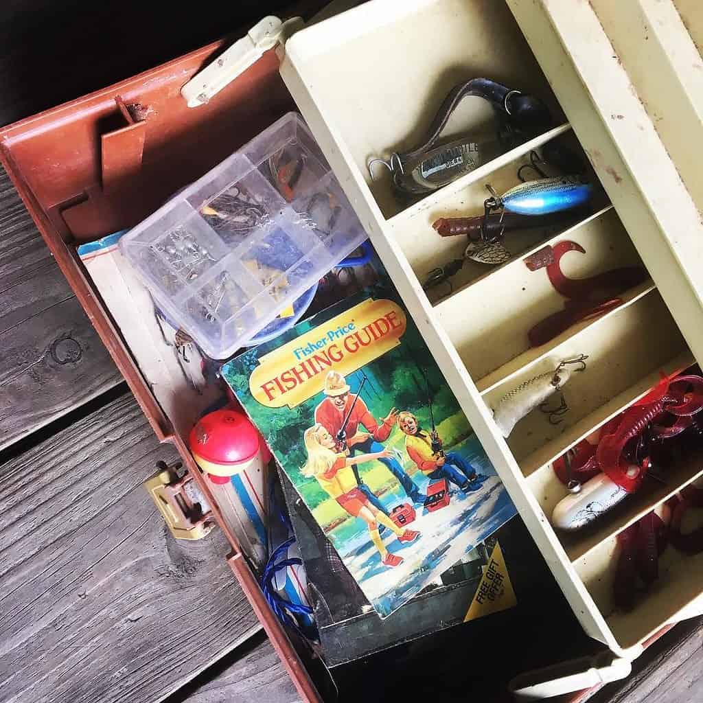 An old tackle box opened to show its lures