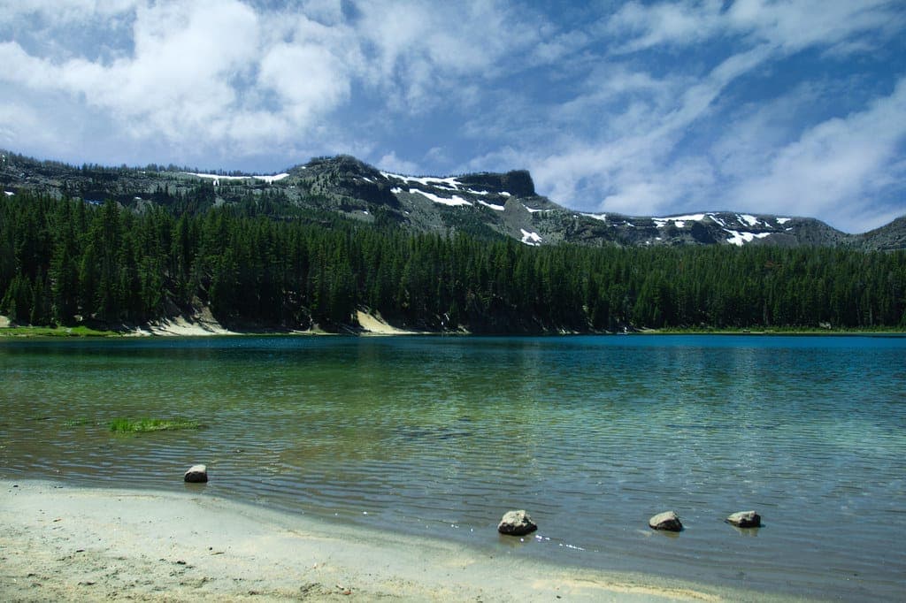 A clear mountain lake with a visible shoreline