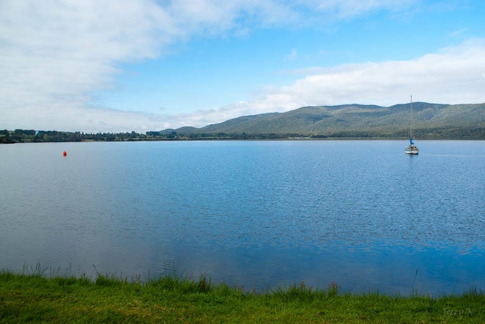 Flat calm water under a pale sky