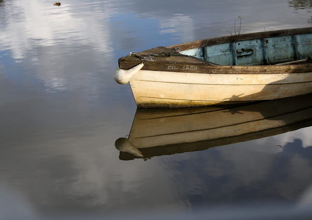 A small boat resting on calm water