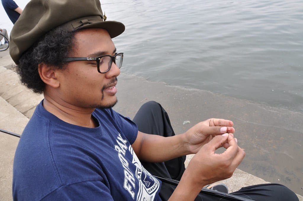 Hands rigging bait onto a hook