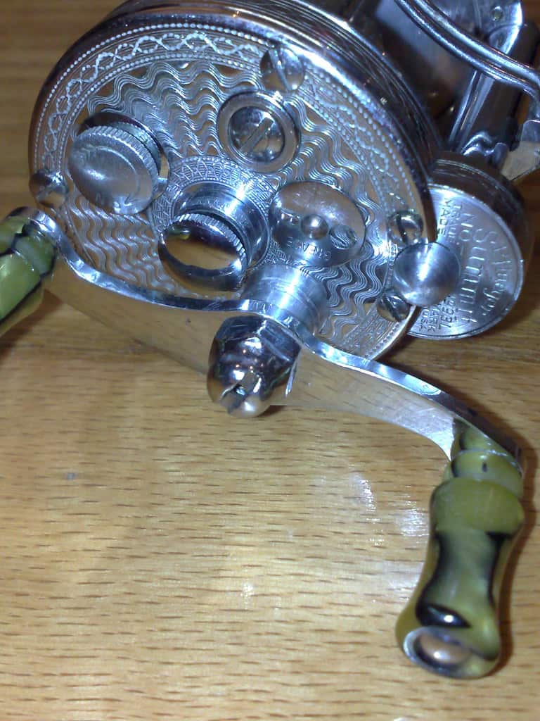 A Pflueger spinning reel photographed on a plain background